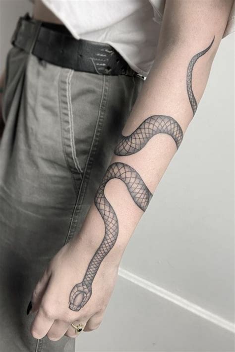 snake tattoo around the arm